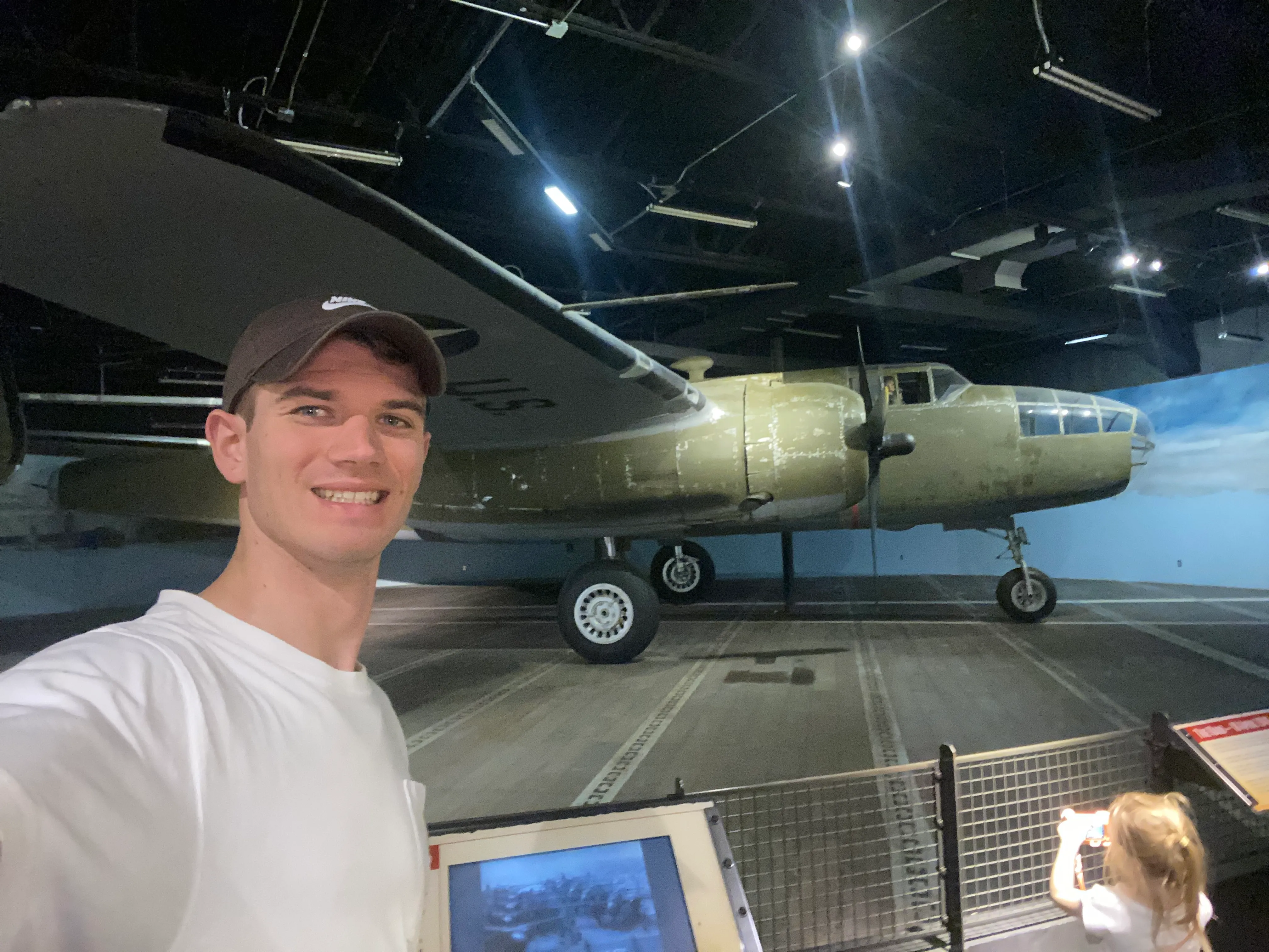 me at nimitz museum with a plane in the background